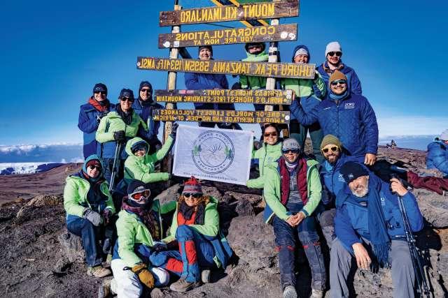 Members of Living Donor Adventures, with whom Dr. H. Albin Gritsch climbed on Mt. Kilimanjaro, celebrate reaching the summit.